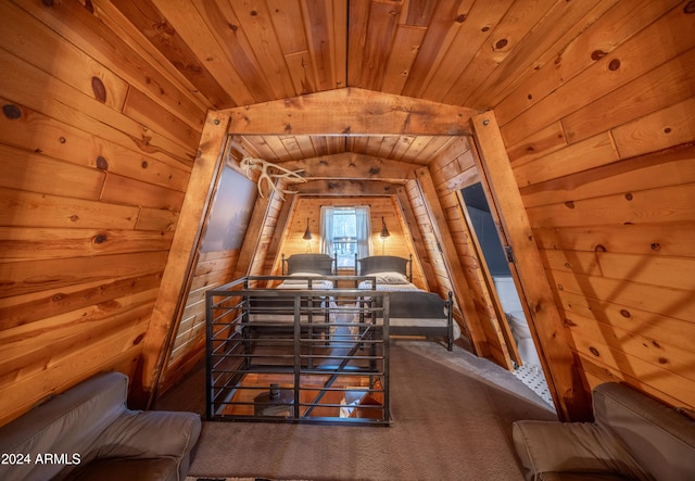 carpeted dining room with lofted ceiling, wooden ceiling, and wooden walls