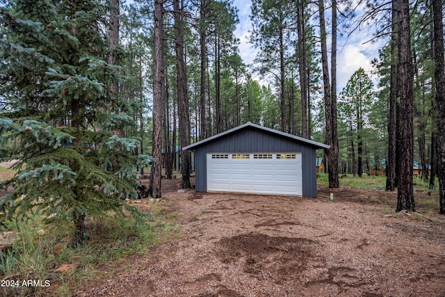 detached garage with a forest view