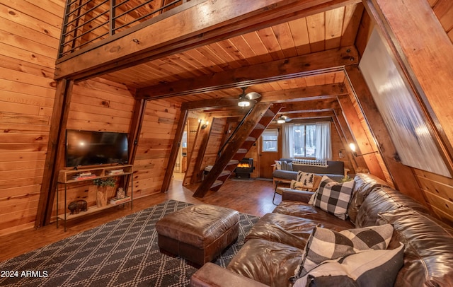 living room featuring wooden ceiling, wood walls, stairs, and dark wood-type flooring