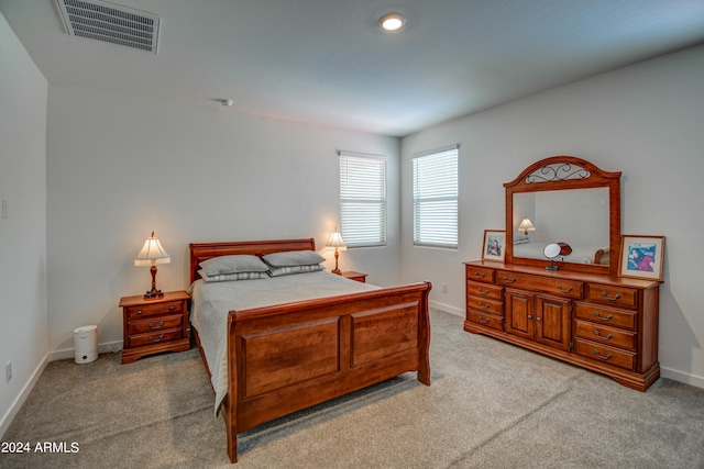 bedroom featuring light colored carpet