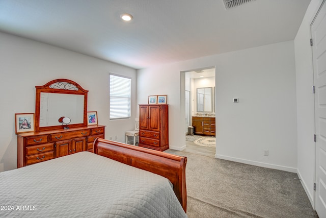 carpeted bedroom with ensuite bath