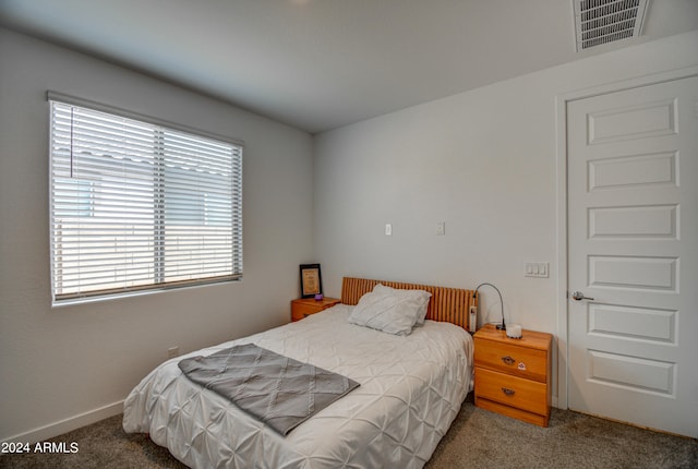 bedroom featuring dark colored carpet