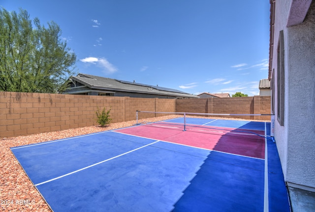 view of sport court featuring tennis court