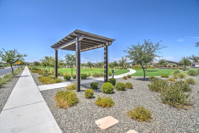 surrounding community featuring a lawn and a pergola