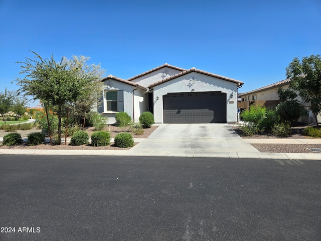 mediterranean / spanish home featuring a garage