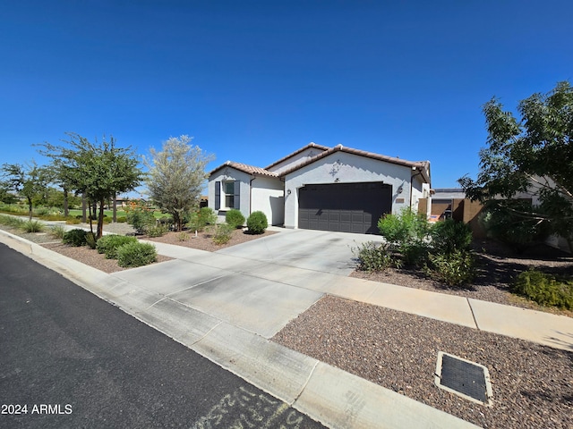 mediterranean / spanish home featuring a garage