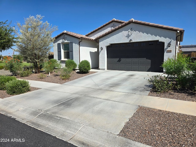 mediterranean / spanish-style home with a garage