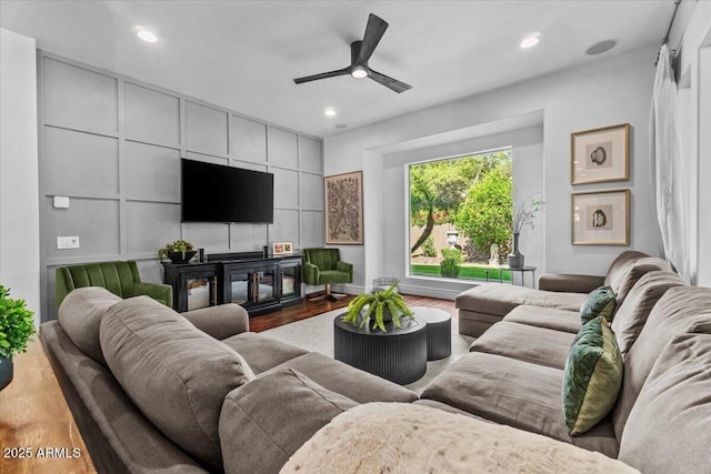 living room featuring recessed lighting, a ceiling fan, and wood finished floors