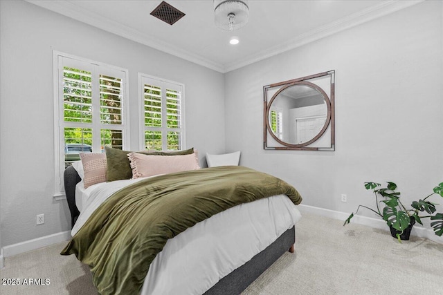 carpeted bedroom featuring crown molding and baseboards