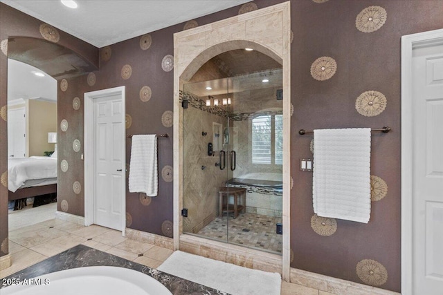 bathroom featuring baseboards, wallpapered walls, a stall shower, and ensuite bath