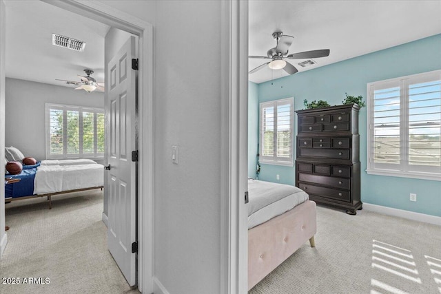 bedroom with visible vents, carpet, and multiple windows