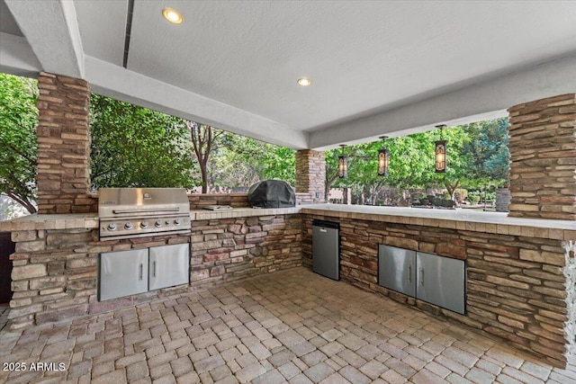 view of patio / terrace featuring exterior kitchen and grilling area