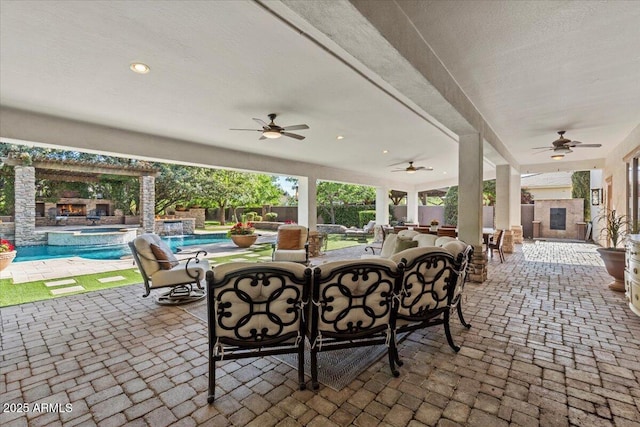 view of patio / terrace with outdoor dining area, a fenced backyard, ceiling fan, and a pool with connected hot tub