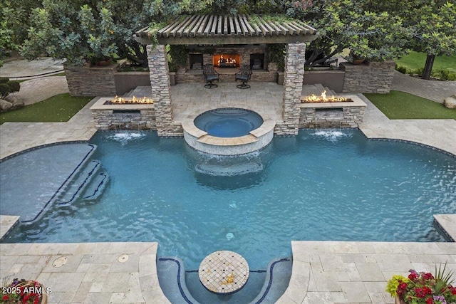 view of pool with a patio, a gazebo, a fire pit, and an outdoor stone fireplace