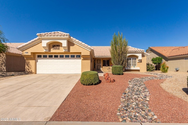 mediterranean / spanish-style house with a garage