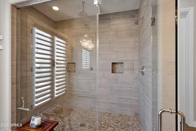 full bathroom with a chandelier and a stall shower