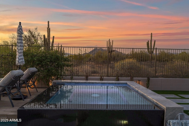 view of swimming pool with fence