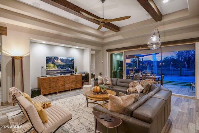 living area featuring beamed ceiling, light wood finished floors, ceiling fan, and recessed lighting