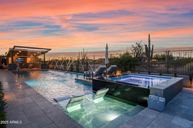 outdoor pool featuring an in-ground hot tub, fence, and a patio area