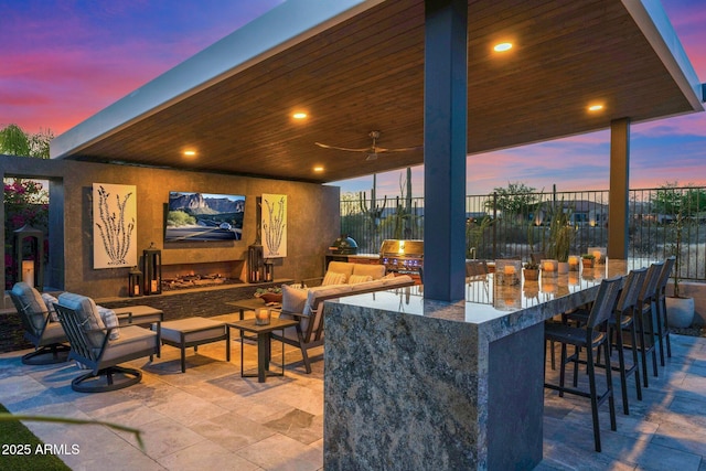 view of patio featuring exterior kitchen, grilling area, and fence