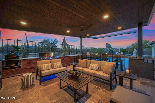 view of patio / terrace featuring an outdoor kitchen, an outdoor hangout area, and a grill