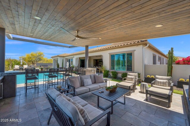 view of patio / terrace featuring outdoor lounge area, exterior kitchen, fence, and grilling area