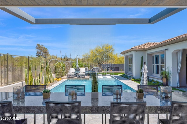 view of pool featuring outdoor dining area, a patio area, and a fenced backyard