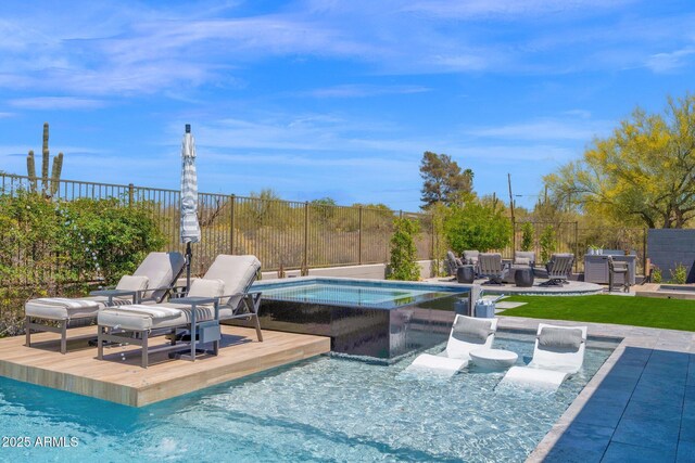 view of pool with fence and an in-ground hot tub