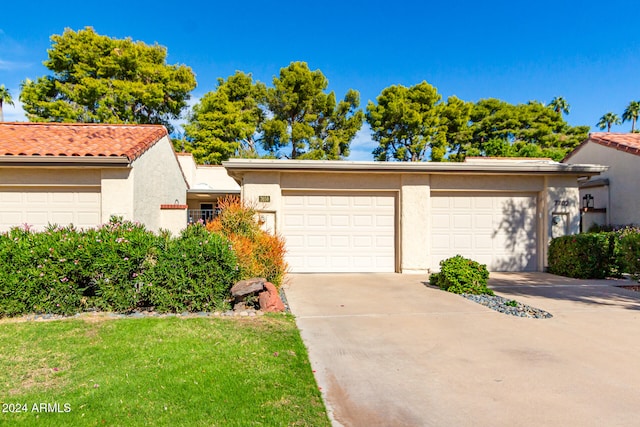 view of front of house with a garage and a front lawn