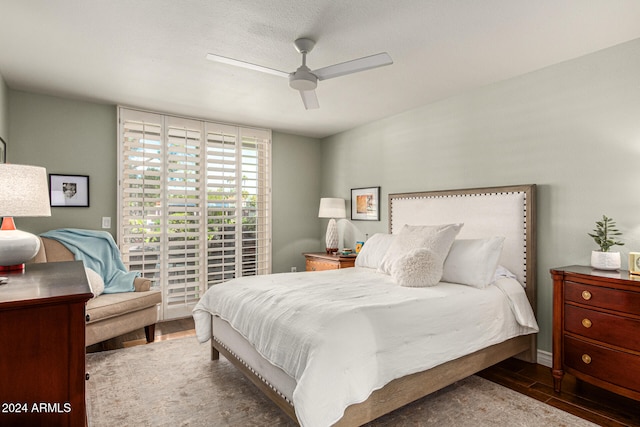 bedroom with ceiling fan and dark hardwood / wood-style floors