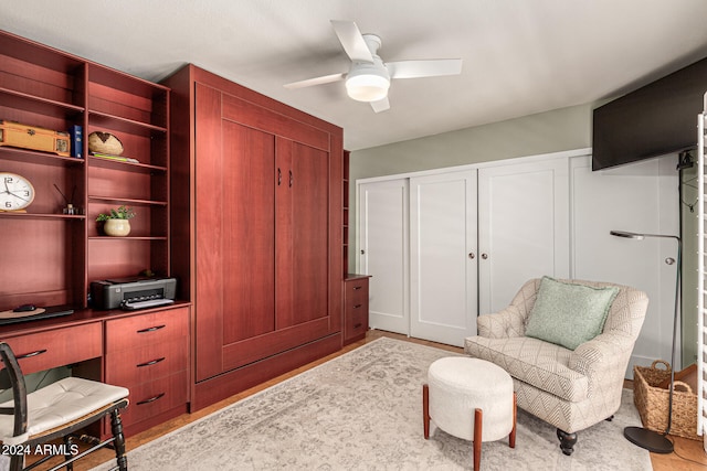 living area featuring ceiling fan