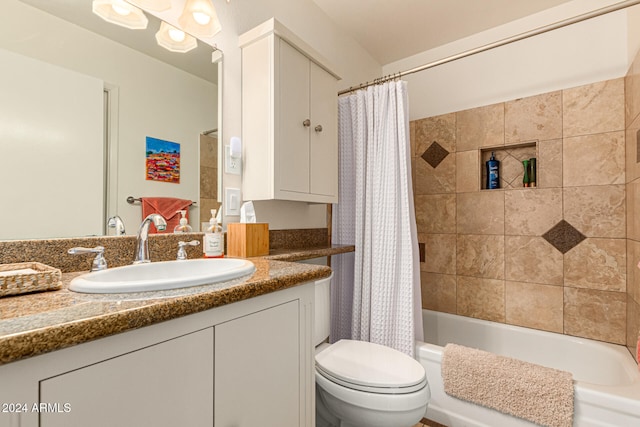 full bathroom with shower / tub combo with curtain, vanity, and toilet