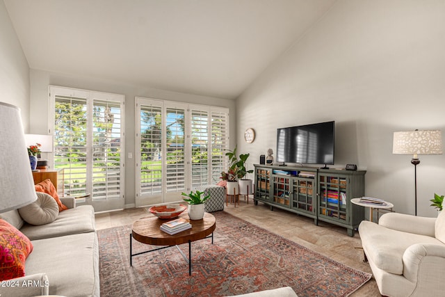 living room with high vaulted ceiling and plenty of natural light