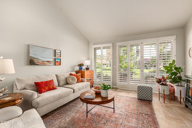 living room featuring high vaulted ceiling