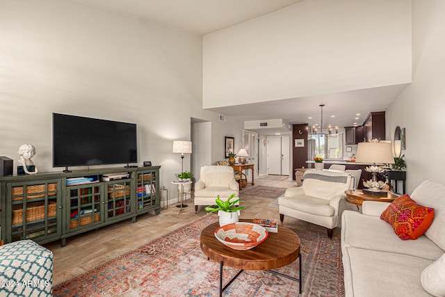 living room with a high ceiling and an inviting chandelier