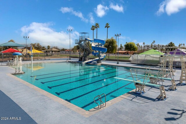 view of swimming pool with a water slide