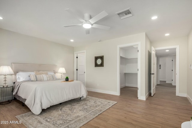 bedroom featuring recessed lighting, visible vents, baseboards, and light wood finished floors