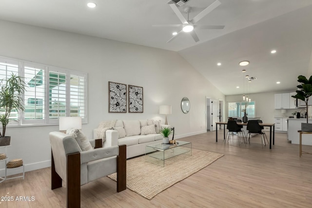 living area with a ceiling fan, baseboards, high vaulted ceiling, recessed lighting, and light wood-type flooring