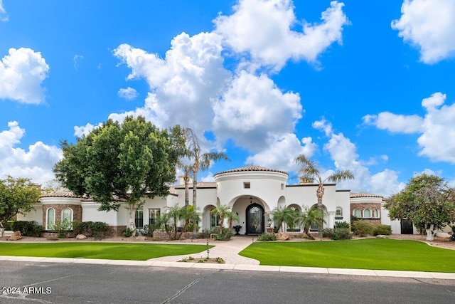 mediterranean / spanish house with a front lawn