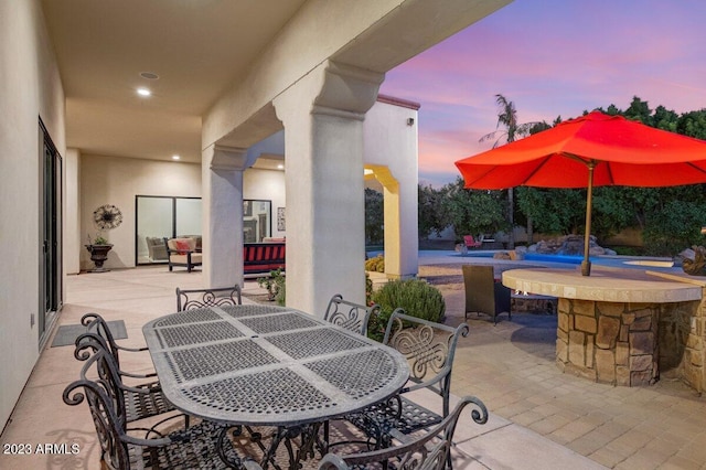 view of patio terrace at dusk