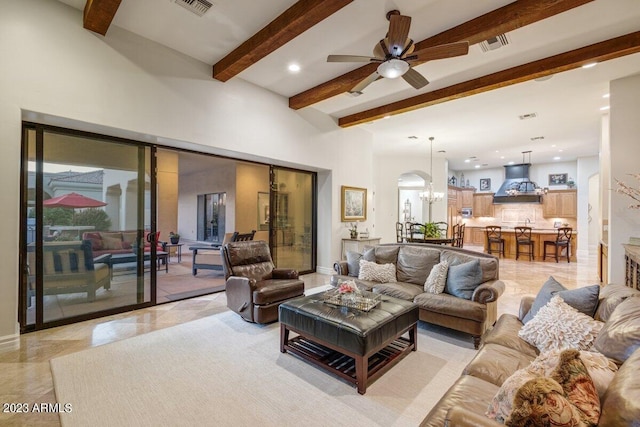 living room featuring beam ceiling and ceiling fan with notable chandelier