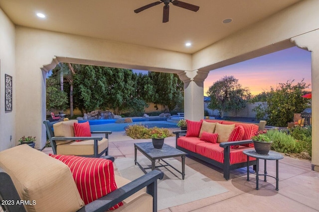 patio terrace at dusk with an outdoor living space and ceiling fan