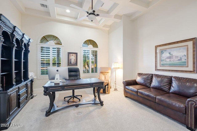 carpeted home office with a high ceiling, ceiling fan, coffered ceiling, and beam ceiling