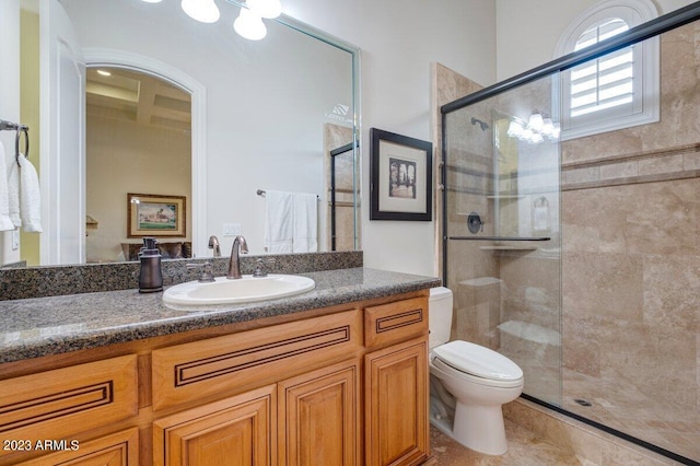 bathroom featuring walk in shower, vanity, and toilet