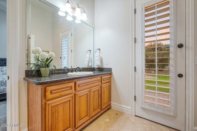 bathroom with vanity, tile patterned floors, and a chandelier