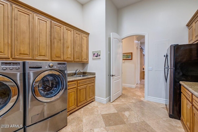 laundry room featuring washing machine and clothes dryer and sink