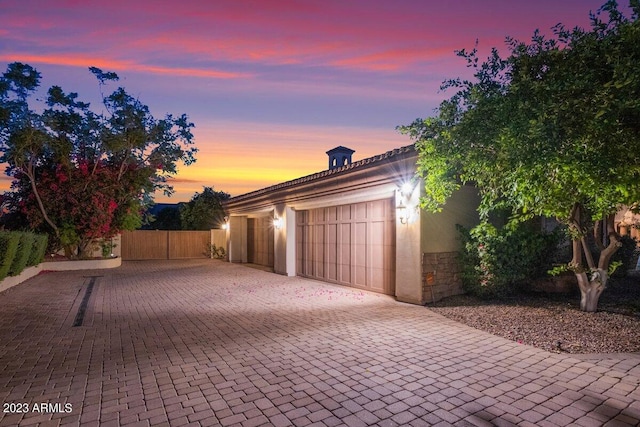 view of garage at dusk