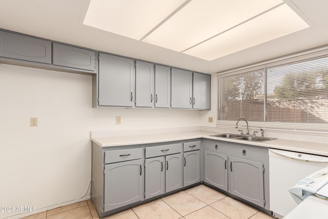 8027 N 32nd Ave, Phoenix, AZ 85051 - kitchen with gray cabinetry, dishwasher, a sink, light tile patterned floors, and light countertops
