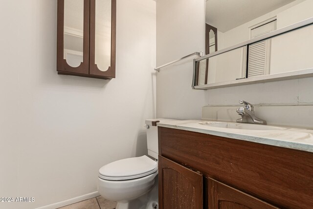 bathroom featuring tile patterned floors, vanity, and toilet