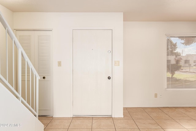 8027 N 32nd Ave, Phoenix, AZ 85051 - foyer with light tile patterned flooring, baseboards, and stairway